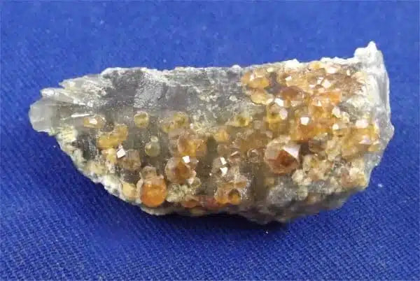 Metaphysical Healing Properties Of Spessartite Garnet On Smokey Quartz